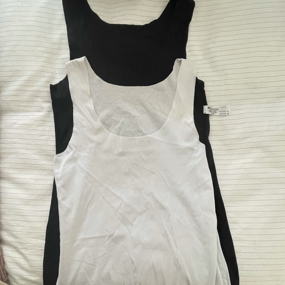 Two black and white tank tops